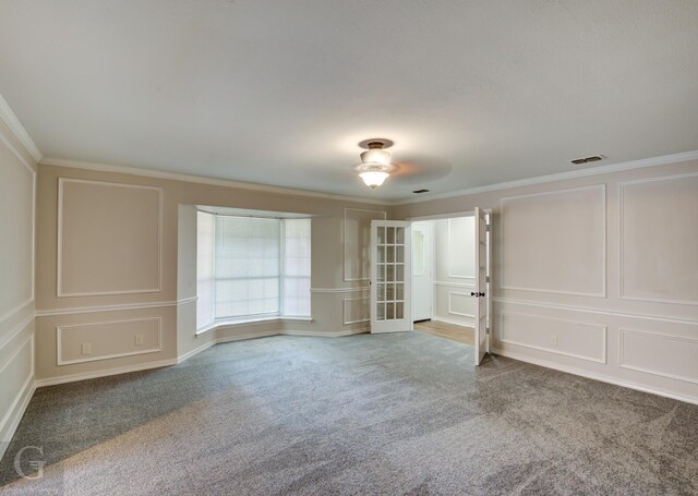 unfurnished room featuring light carpet, ornamental molding, and french doors