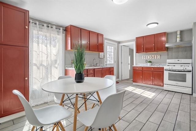 kitchen featuring white gas range and sink