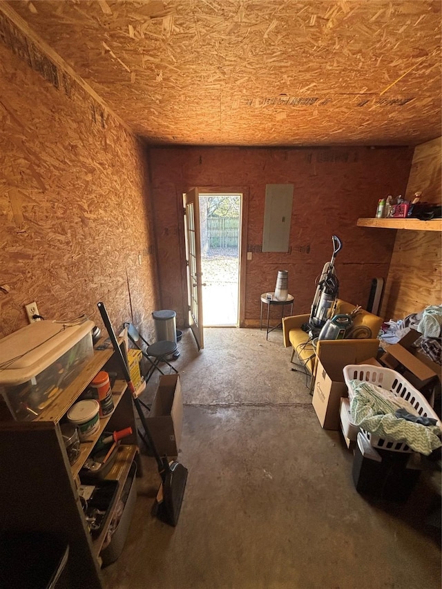 miscellaneous room featuring electric panel and concrete floors