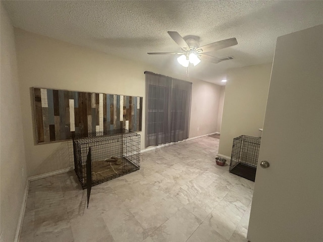 unfurnished living room featuring a textured ceiling and ceiling fan