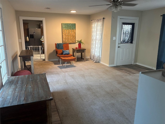 carpeted entrance foyer with ceiling fan