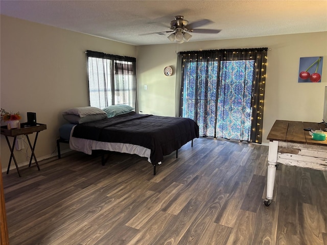 bedroom featuring dark wood-type flooring and a textured ceiling