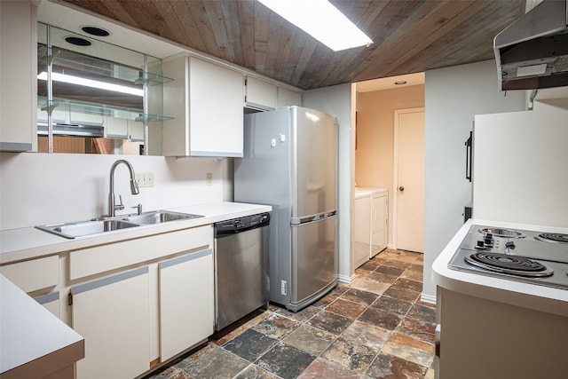 kitchen featuring wood ceiling, washer and clothes dryer, stainless steel appliances, extractor fan, and white cabinets