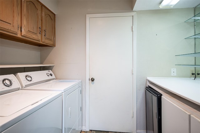 laundry area with cabinets and washer and clothes dryer