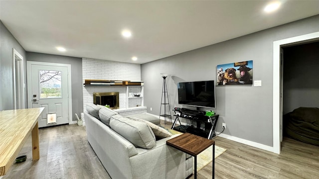 living room featuring hardwood / wood-style flooring and a fireplace