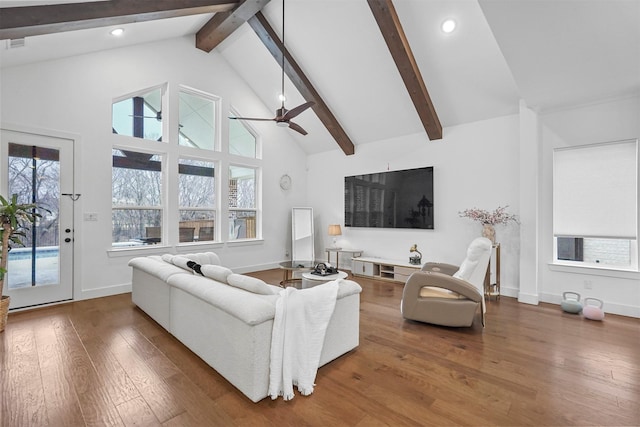 living room with ceiling fan, hardwood / wood-style flooring, high vaulted ceiling, and beamed ceiling