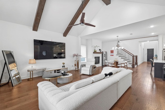 living room with beamed ceiling, dark hardwood / wood-style flooring, ceiling fan with notable chandelier, and high vaulted ceiling