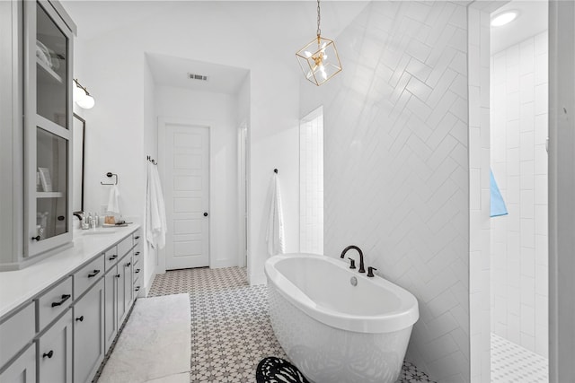 bathroom with vanity, plus walk in shower, and tile walls