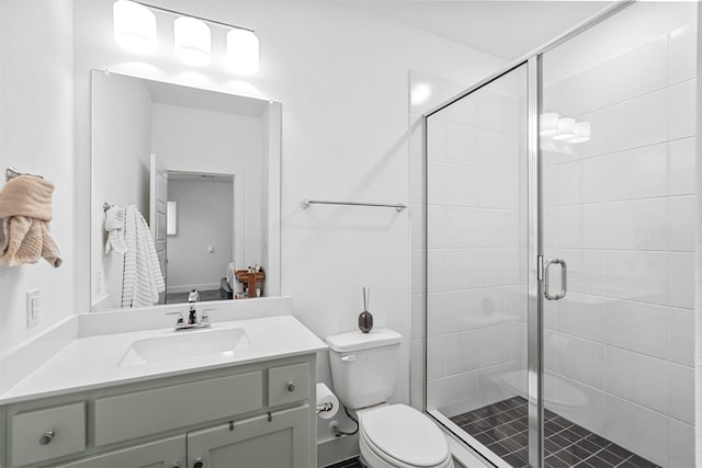 bathroom with vanity, toilet, and an enclosed shower