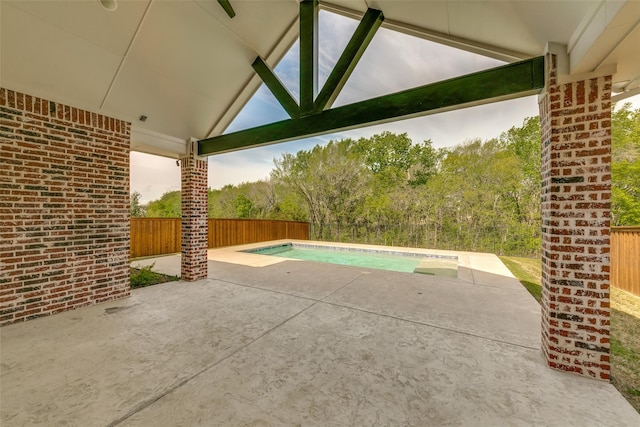 view of patio / terrace with a fenced in pool