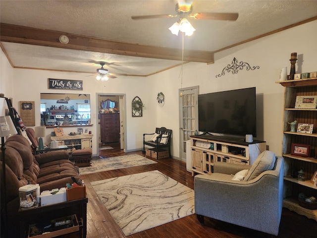 living room with dark wood-type flooring, a textured ceiling, and beam ceiling