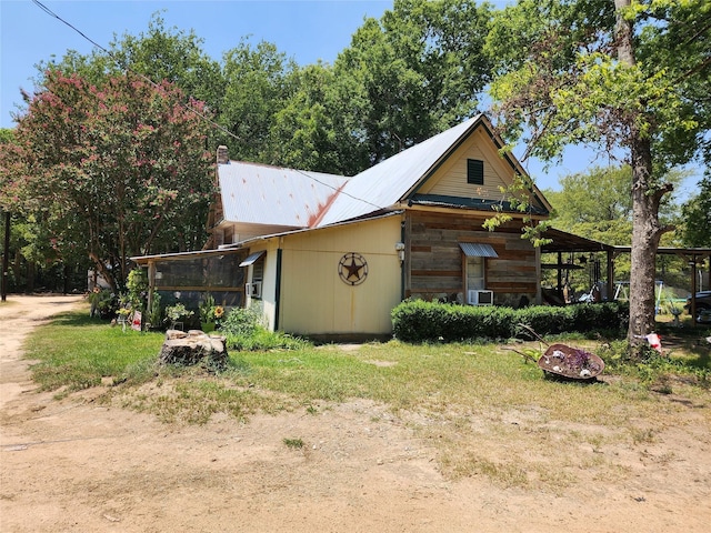 view of side of property with a lawn