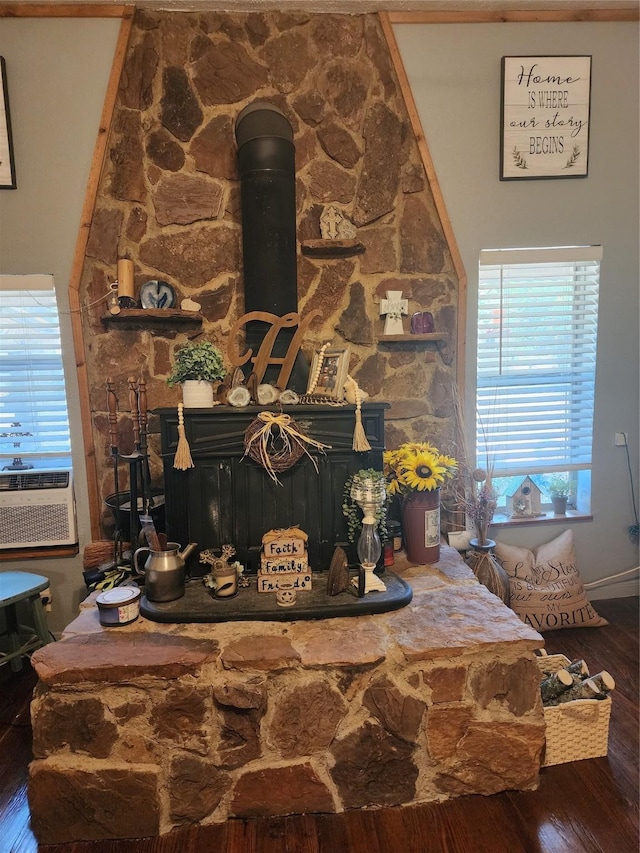 interior details featuring cooling unit, hardwood / wood-style floors, and a wood stove