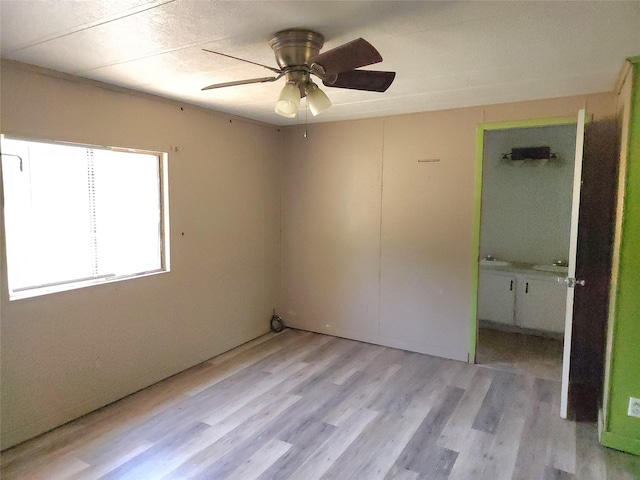 unfurnished bedroom with ceiling fan and light hardwood / wood-style floors