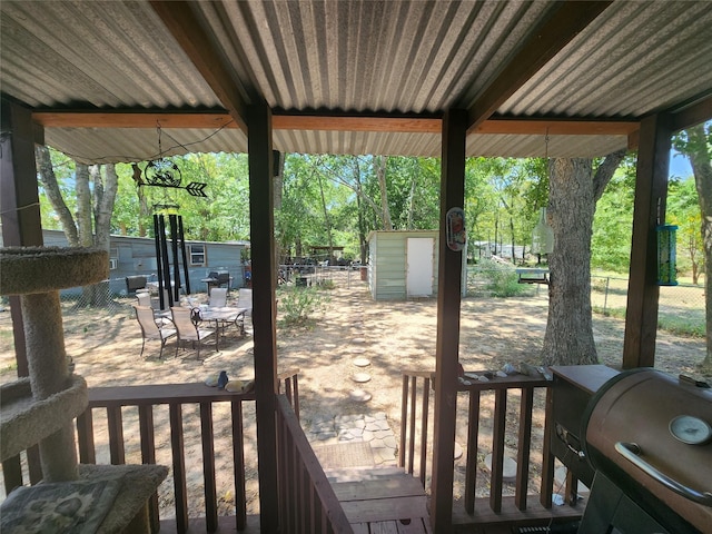 exterior space with a grill and a storage shed