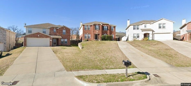 view of front of house with a garage and a front lawn