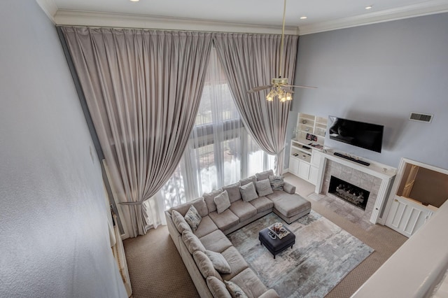 carpeted living room featuring ornamental molding and a fireplace