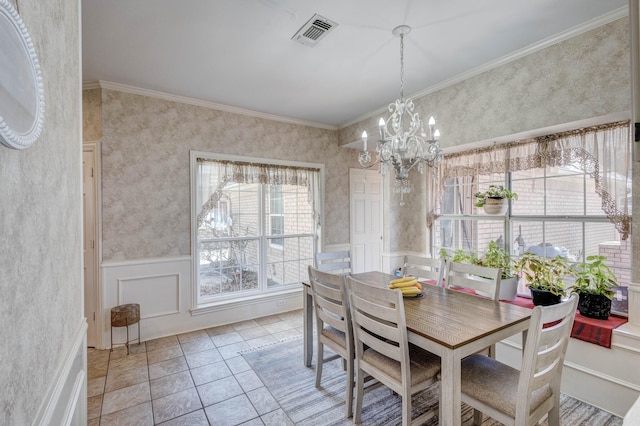 dining area featuring crown molding, light tile patterned floors, and a notable chandelier