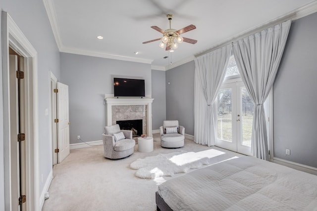 carpeted bedroom featuring a tiled fireplace, crown molding, access to outside, and french doors