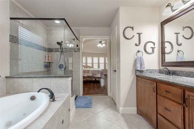 bathroom featuring ceiling fan, vanity, shower with separate bathtub, and tile patterned flooring