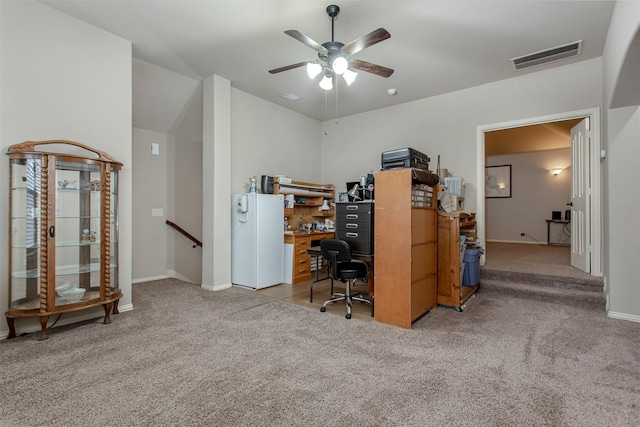 office area featuring light carpet and ceiling fan