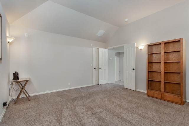 interior space featuring vaulted ceiling and carpet