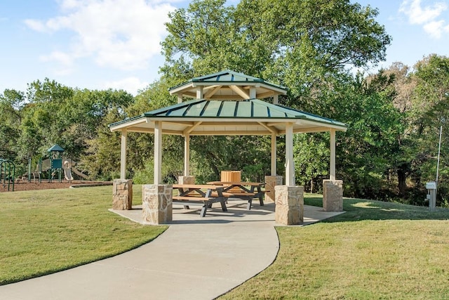 view of community with a gazebo, a playground, and a lawn