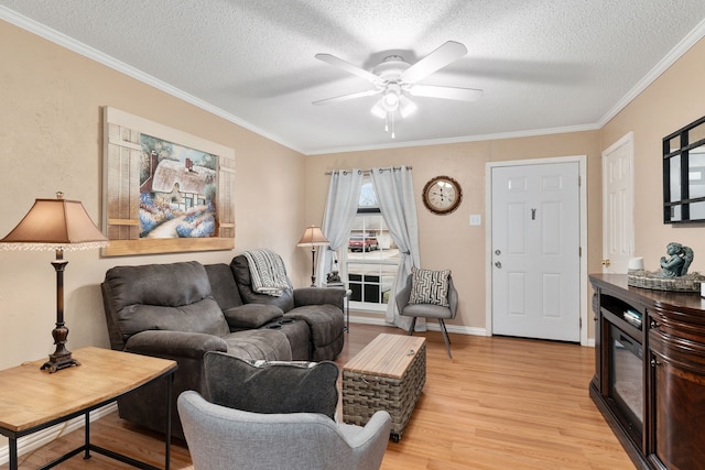 living room with crown molding, light hardwood / wood-style floors, ceiling fan, and a textured ceiling