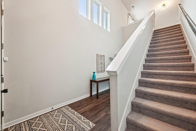 staircase featuring wood-type flooring