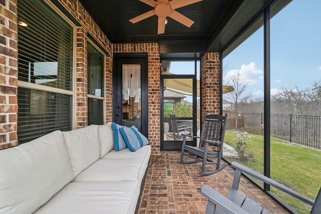 unfurnished sunroom featuring ceiling fan