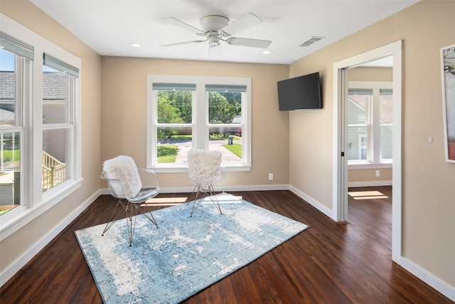 sitting room with dark hardwood / wood-style flooring and ceiling fan