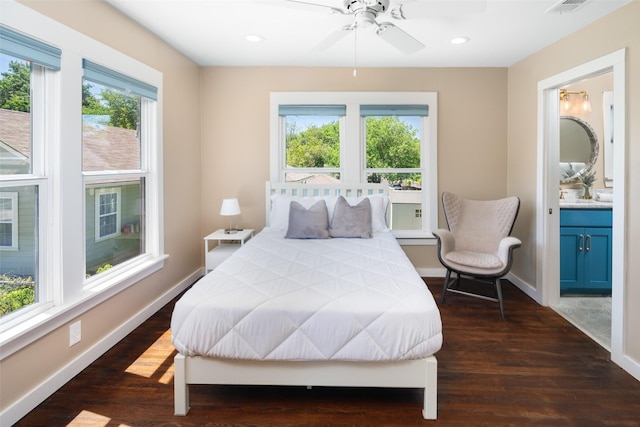 bedroom with multiple windows, dark hardwood / wood-style flooring, ceiling fan, and ensuite bathroom