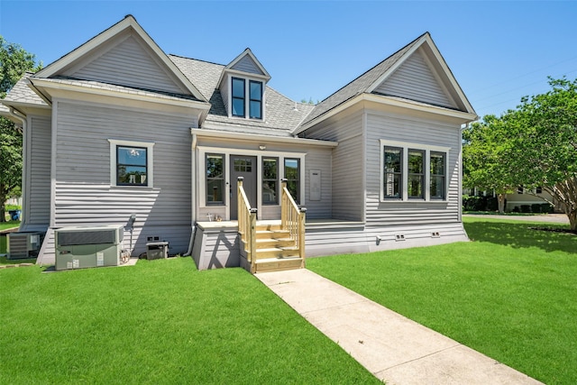 view of front of home featuring a front lawn and central air condition unit