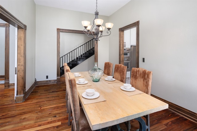 dining area with dark hardwood / wood-style floors and a chandelier