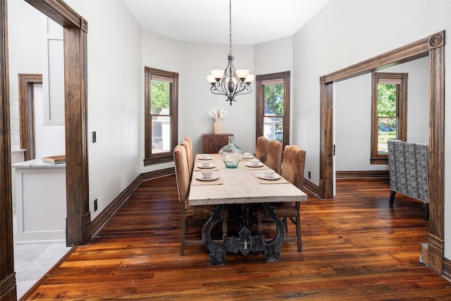 dining space featuring dark hardwood / wood-style floors and a notable chandelier