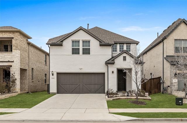 front facade featuring a garage and a front lawn