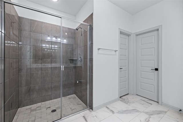 bathroom featuring a shower with shower door