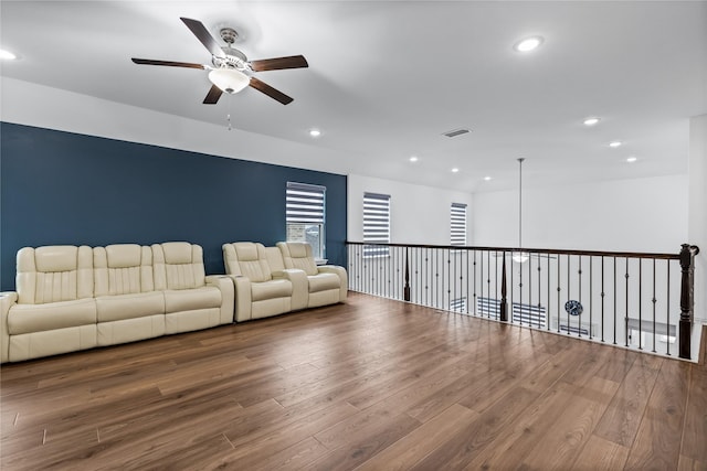 unfurnished living room featuring ceiling fan and hardwood / wood-style floors