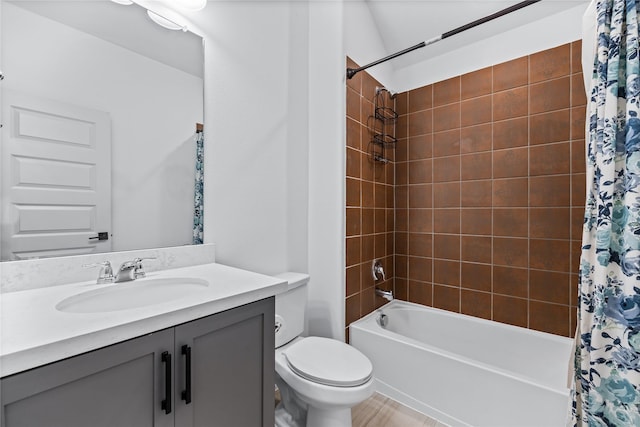 full bathroom with vanity, shower / bath combo with shower curtain, and toilet