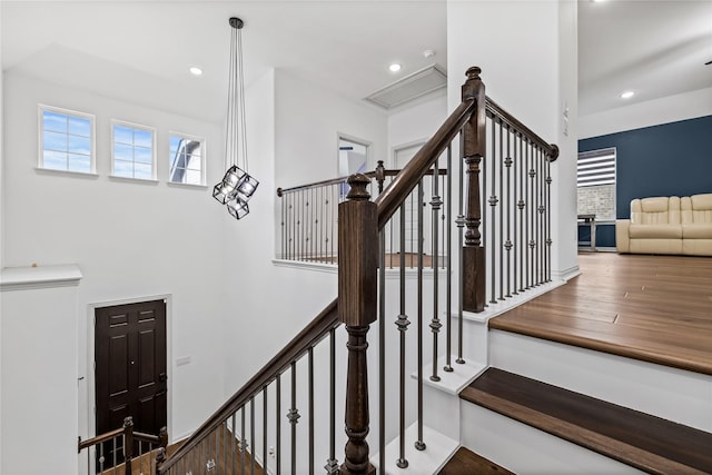 staircase with hardwood / wood-style flooring