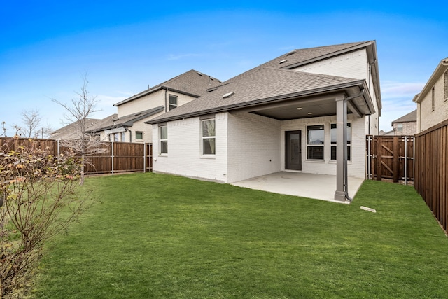 back of property with a patio and a yard