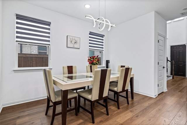 dining room featuring hardwood / wood-style floors and an inviting chandelier