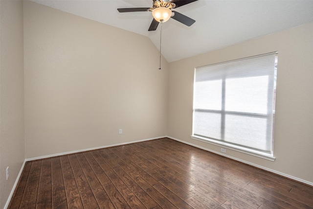 empty room featuring dark hardwood / wood-style flooring, vaulted ceiling, and ceiling fan