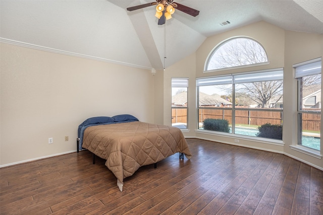 bedroom with ceiling fan, dark hardwood / wood-style floors, and vaulted ceiling