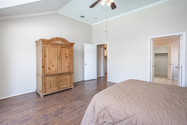 bedroom featuring ceiling fan, ornamental molding, lofted ceiling, and dark hardwood / wood-style floors