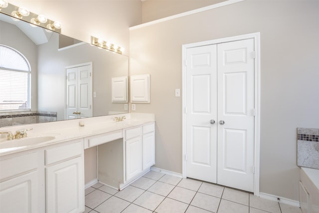 bathroom with tile patterned flooring, vanity, and lofted ceiling