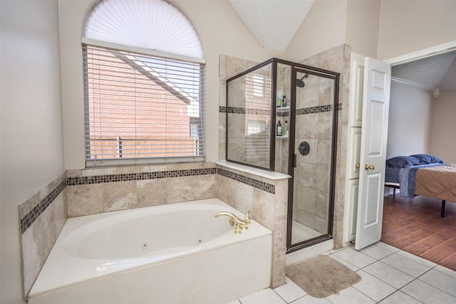 bathroom featuring tile patterned floors, shower with separate bathtub, vaulted ceiling, and a textured ceiling