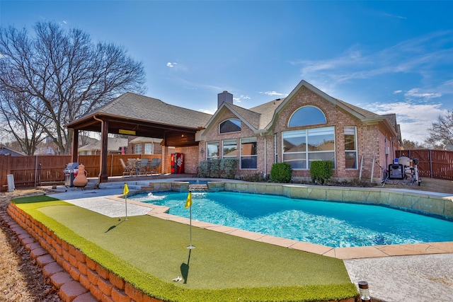 view of pool with pool water feature and a patio area