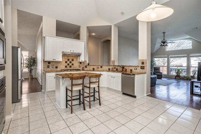 kitchen featuring white cabinetry, appliances with stainless steel finishes, sink, and a center island