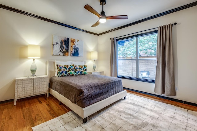 bedroom featuring ornamental molding, light hardwood / wood-style floors, and ceiling fan